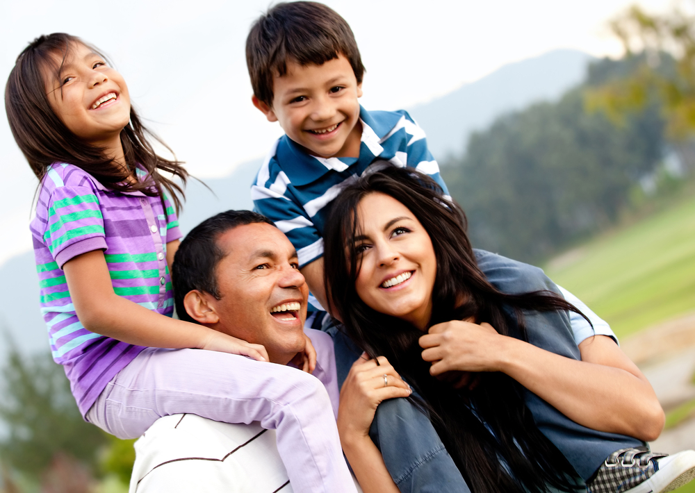 Beautiful family portrait outdoors looking very happy