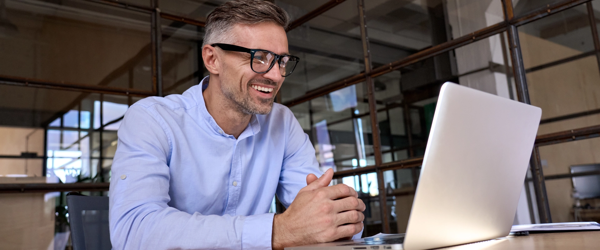 Mature man at computer smiling